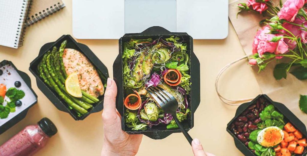 7 Ways to Pull off a Successful Food Truck Concept - food in takeaway containers in front of a laptop