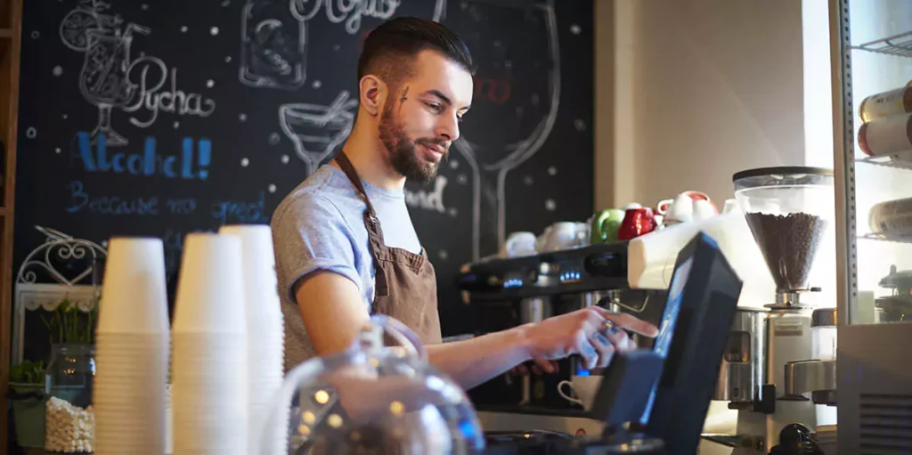 barista using POS system