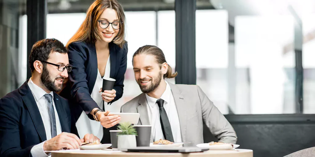 Business people having fun sitting together during the coffee break in the modern cafe intreior