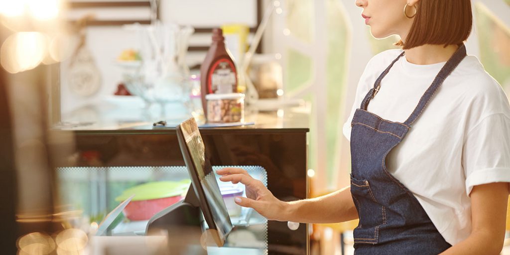 female barista using a POS system