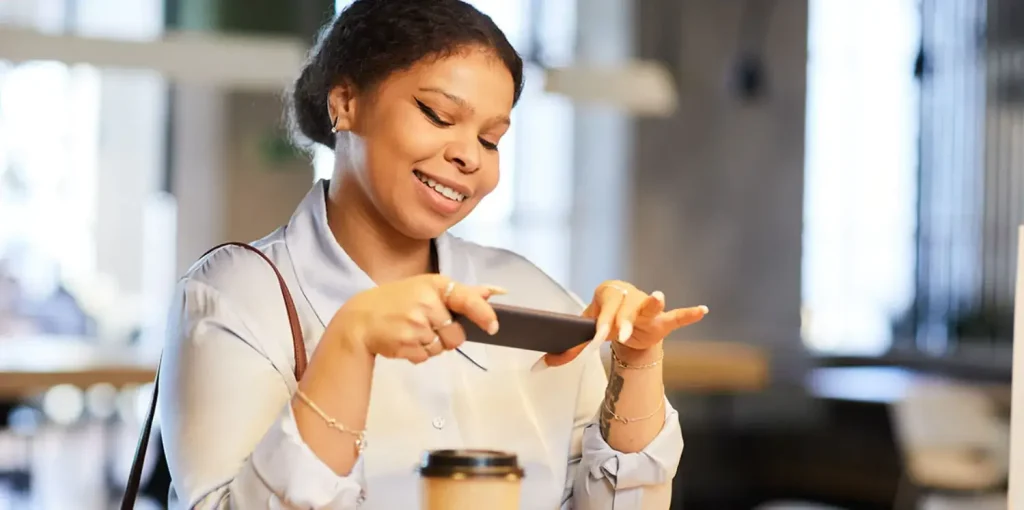 woman taking photo of food