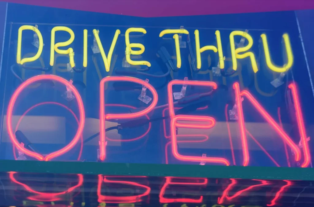 Banner of drive-thru which says open