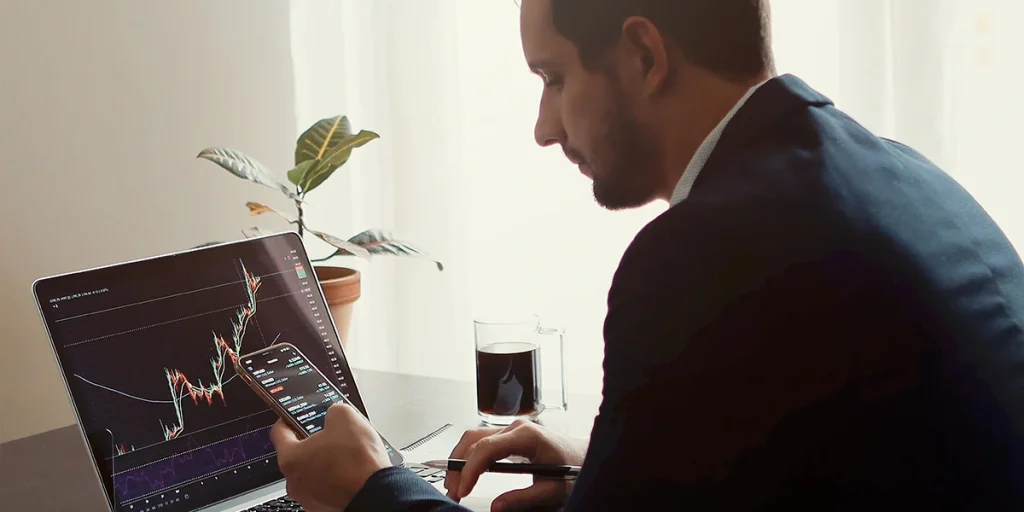 man looking up investment values