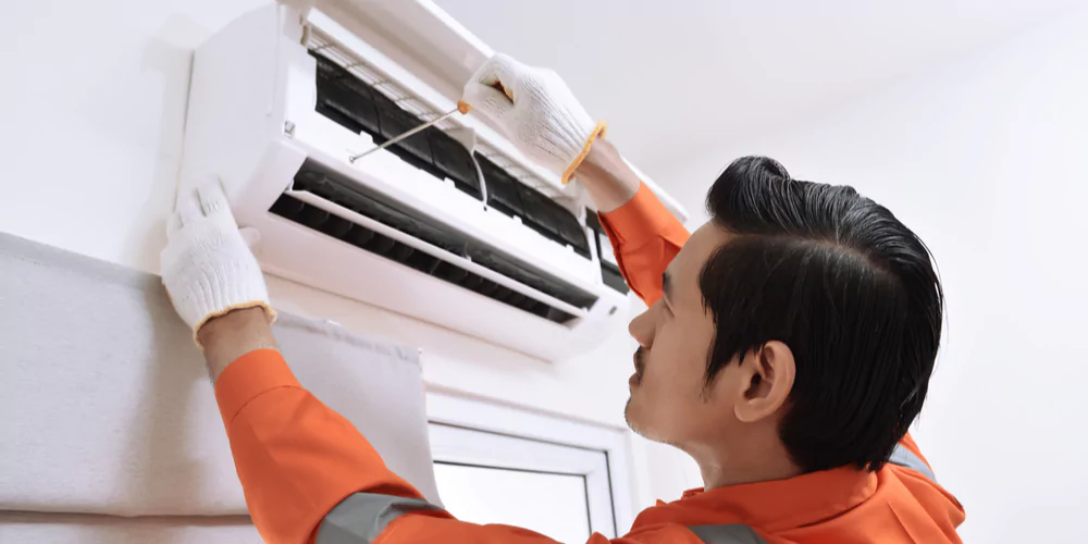 technician conducting maintenance on appliances to save on restaurant electricity costs