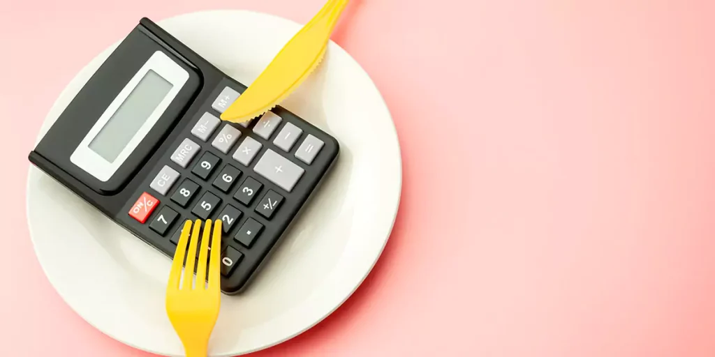 restaurant franchise costs represented by a calculator on a plate