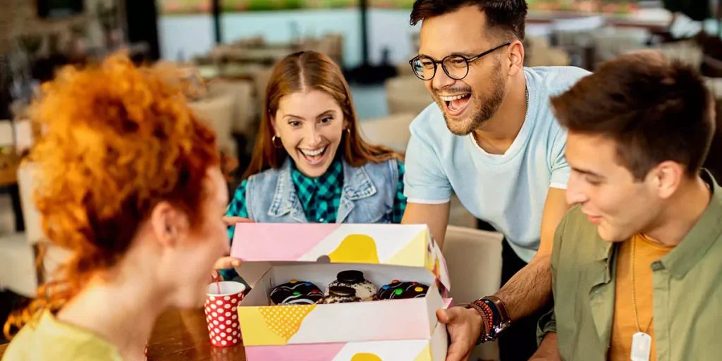 Group of friends with a box of donuts