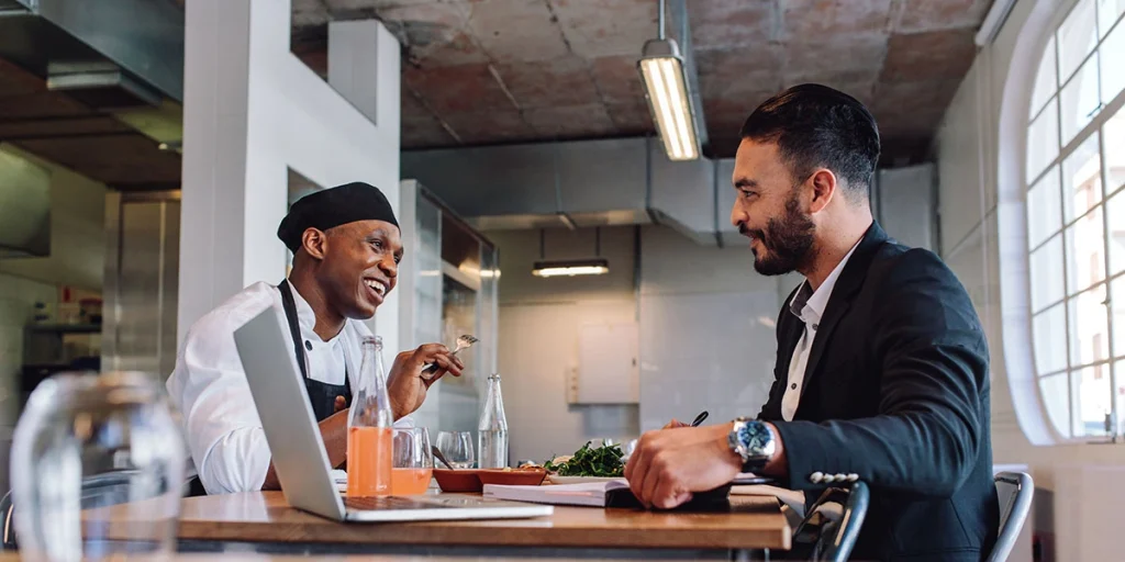 Restaurant owner conversing with a chef