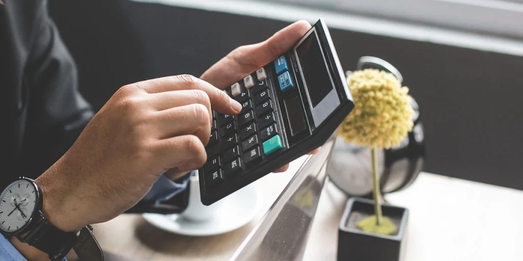 Person using a calculator in a restaurant